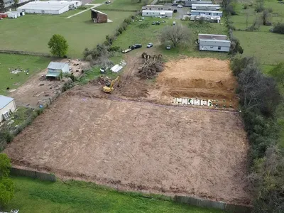 Aerial view of a cleared site with a new septic drain field area being prepared