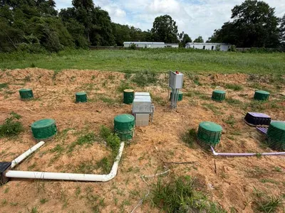 Septic system control panel and green risers on a dispersal field