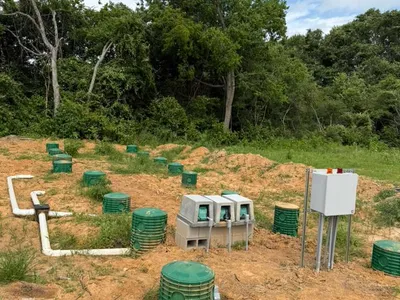Control panel and green risers on a septic drip dispersal field