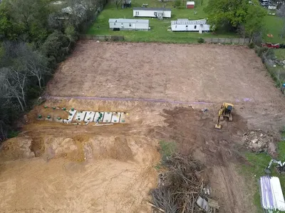 Aerial view of an excavator working on a septic drain field site