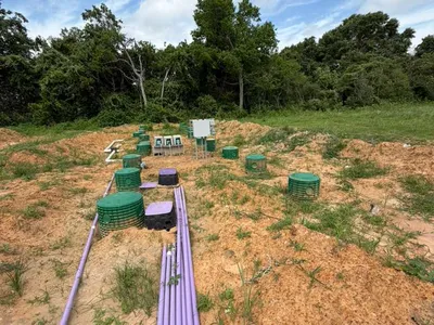 Purple drip lines leading to green risers in a drip field